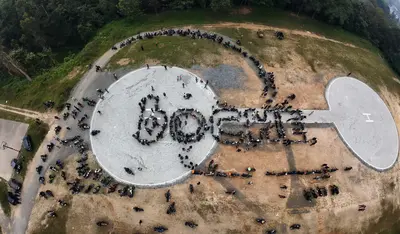 Helipad Drone View of boCHE Convoy An aerial drone view of motorcycles perfectly arranged to spell out boCHE on the helipad grounds during a massive biker rally at boCHE 1000 Acre, one of the best resorts in Wayanad.
