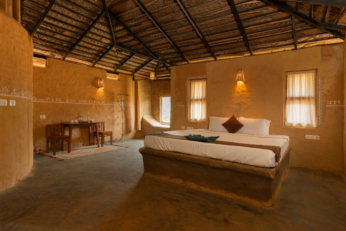 Earthy Bedroom in Mud House Rustic wooden double bed and earthy decor in the mud house wayanad rooms