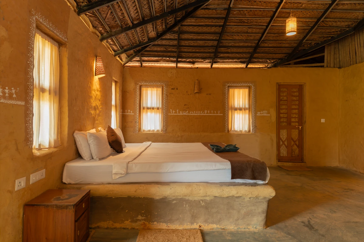 Mud House Room Interior Rustic wooden double bed and earthy decor in the mud house wayanad rooms