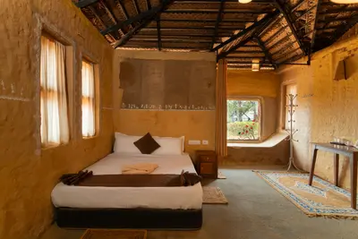 Rustic wooden double bed and earthy decor in the mud house wayanad rooms