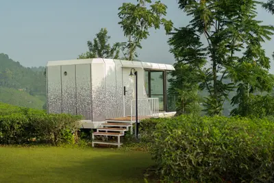 Futuristic xpod wayanad villa exterior with glass front at boCHE 1000 Acres resort in wayanad