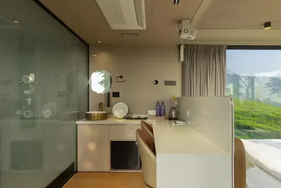 Ultra-modern room interior with a sleek counter and tea plantation views at boCHE 1000 Acre, one of the best resorts in Wayanad.