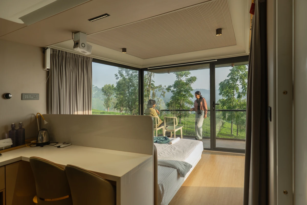XPod Panoramic View Bedroom Luxury double bed with floor-to-ceiling plantation views inside xpod boche 1000 acre resort wayanad