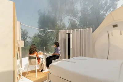 Luxury climate-controlled bedroom setup inside transparent bubble dome wayanad