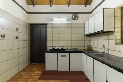 Fully equipped modern kitchen inside Mountain Residence, perfect for wayanad resort packages