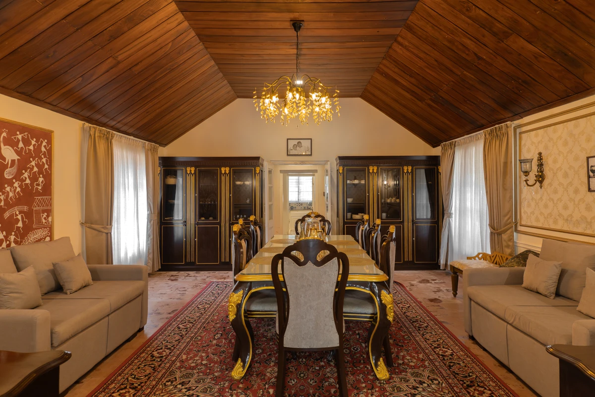 Dining Room with Glass Table Elegant dining room with a luxury glass table and chandelier at boCHE 1000 Acre, one of the best resorts in Wayanad.
