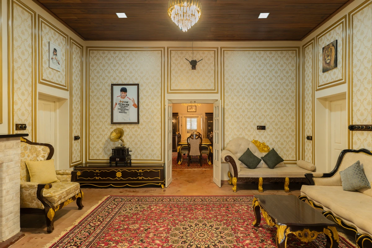 Royal Living Room with Antique Furniture Royal living room with luxury antique-style furniture and a large carpet at boCHE 1000 Acre, one of the best resorts in Wayanad.