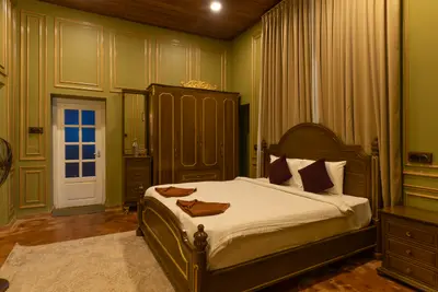Luxurious royal-themed villa bedroom at boCHE 1000 Acre resort, offering a premium stay in Wayanad.