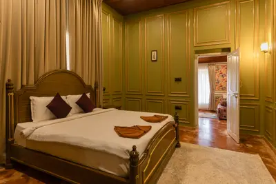 Luxurious royal-themed villa bedroom at boCHE 1000 Acre resort, offering a premium stay in Wayanad