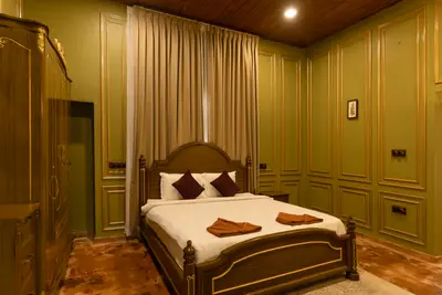Luxurious royal-themed villa bedroom at boCHE 1000 Acre resort, offering a premium stay in Wayanad
