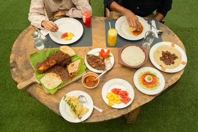An authentic outdoor Kerala dining experience featuring a large spread of local delicacies at boCHE 1000 Acre resort in Wayanad.